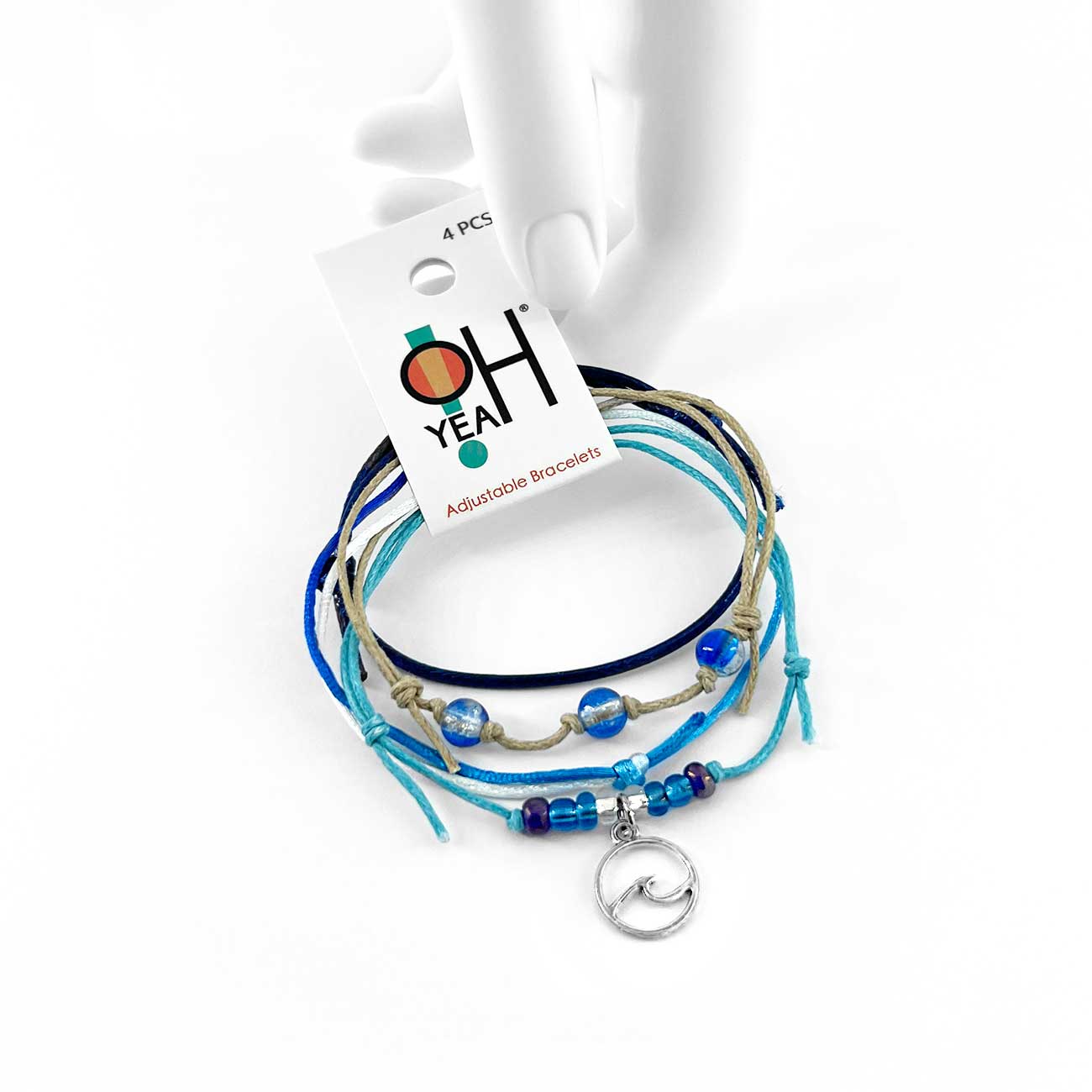 wave bracelet pack with blue and beige cords, silver-tone wave charm and O Yeah hang tag held by a white mannequin hand.