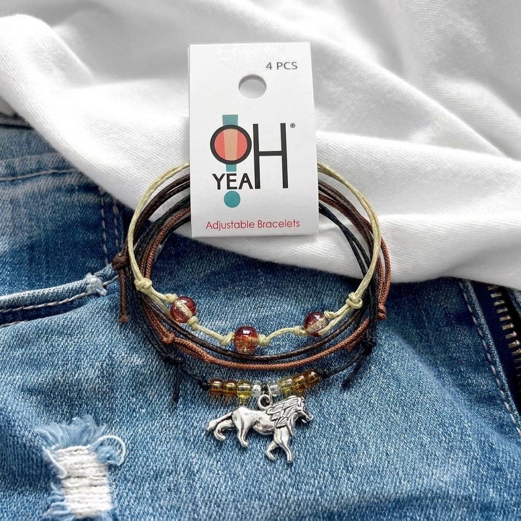 lion bracelet pack with silver-tone lion charm and O Yeah tag on faded blue denim beneath white fabric.